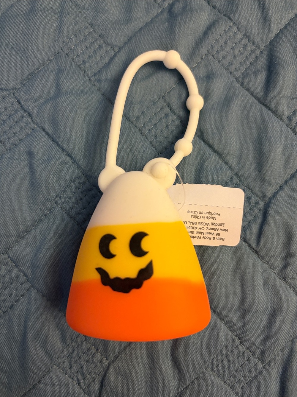 Bath and Bodywork’s Candy Corn Hand Sanitizer Holder - White, Yellow, Orange